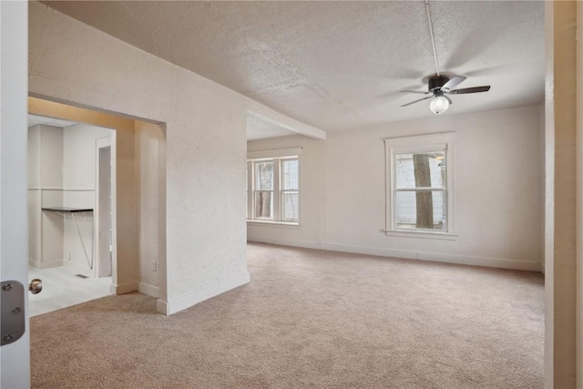 carpeted spare room with ceiling fan and a textured ceiling