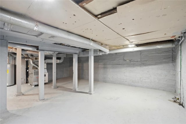 basement featuring heating unit and gas water heater