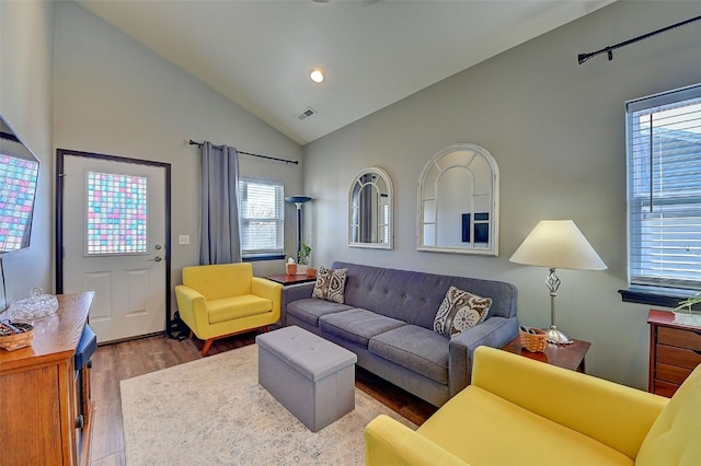 living room with wood-type flooring and vaulted ceiling