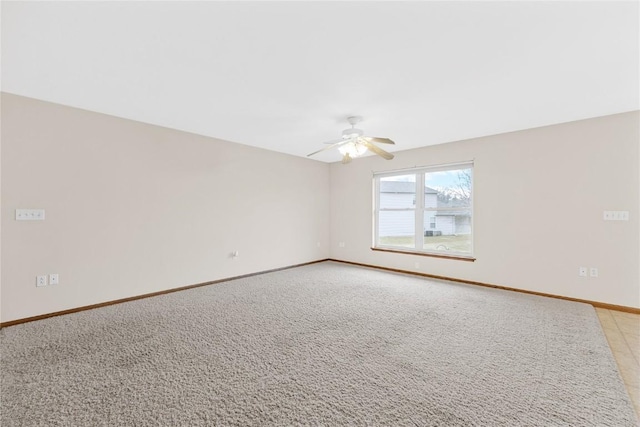 spare room featuring ceiling fan and light colored carpet