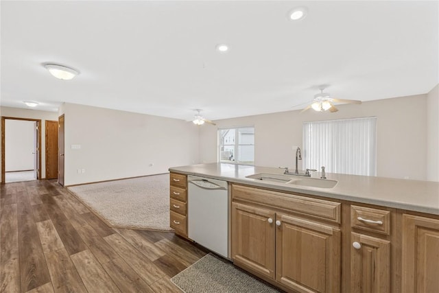 kitchen with dishwasher, sink, ceiling fan, and dark hardwood / wood-style flooring