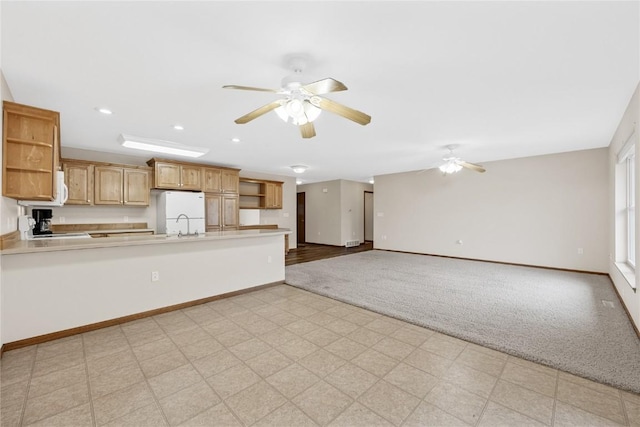 kitchen with ceiling fan, white appliances, and kitchen peninsula