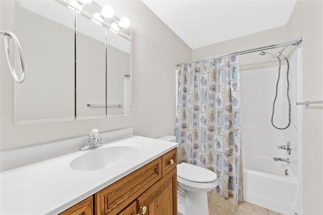 full bathroom featuring vanity, tile patterned flooring, toilet, and shower / bath combo with shower curtain