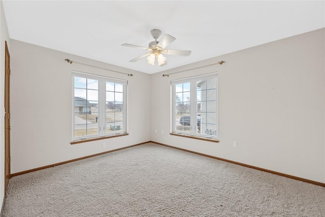 spare room with ceiling fan and carpet flooring