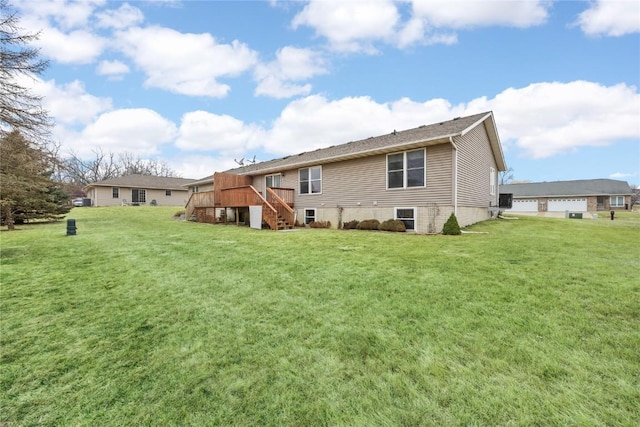 rear view of property with a yard and a deck