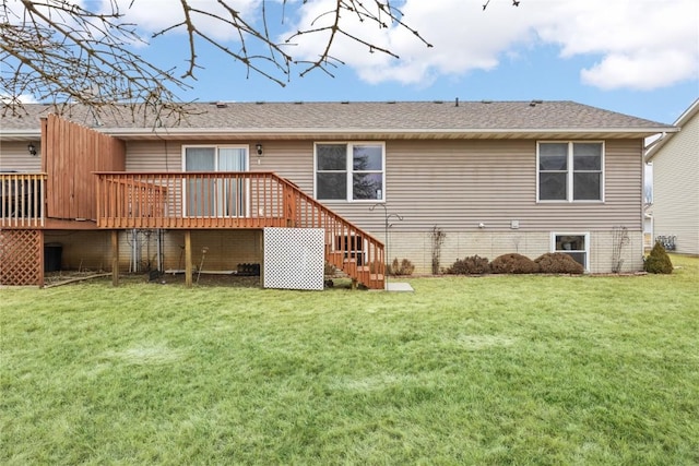 rear view of property featuring a wooden deck and a yard