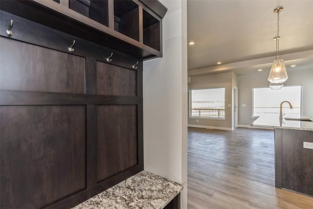 mudroom featuring sink and light hardwood / wood-style flooring