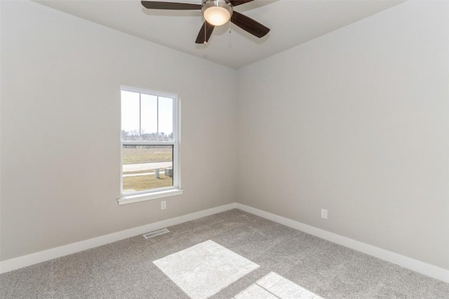 carpeted spare room featuring ceiling fan