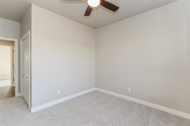 unfurnished room featuring light carpet and ceiling fan