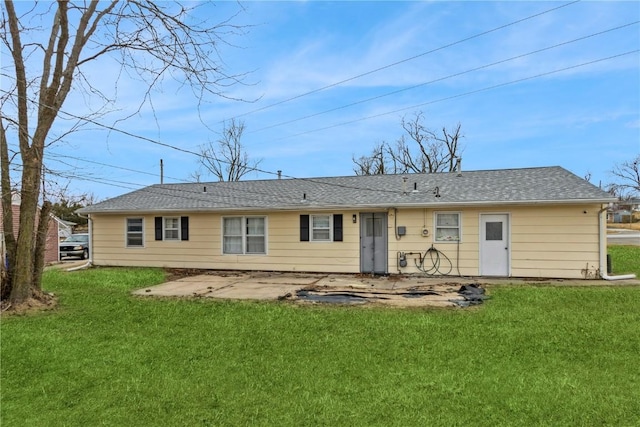 rear view of house featuring a lawn and a patio area