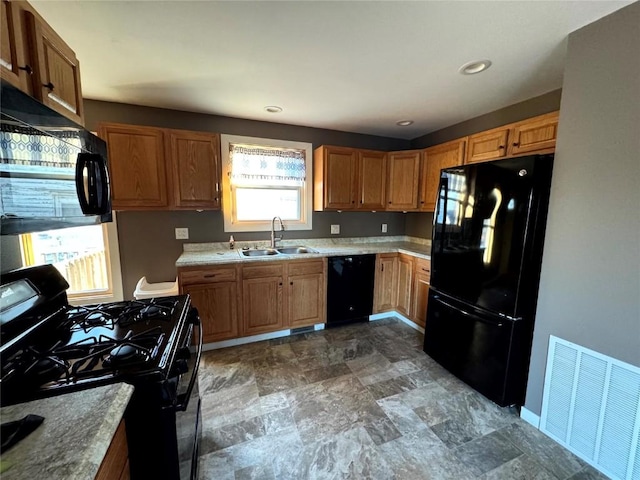 1609 11th Ave, Belle Plaine, IA 52208 - kitchen with visible vents, a sink, baseboards, light countertops, and black appliances