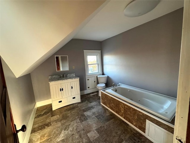 1609 11th Ave, Belle Plaine, IA 52208 - full bathroom featuring vanity, toilet, baseboards, a tub with jets, and vaulted ceiling