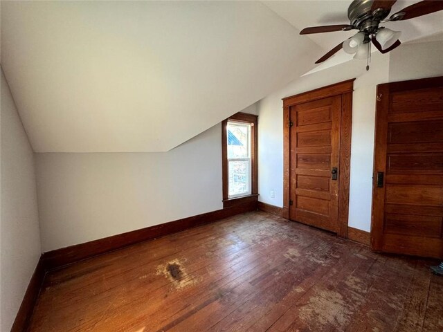 1609 11th Ave, Belle Plaine, IA 52208 - additional living space featuring baseboards, dark wood-style flooring, ceiling fan, and lofted ceiling