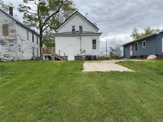 1609 11th Ave, Belle Plaine, IA 52208 - rear view of property featuring a yard and metal roof