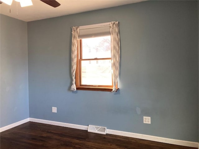 empty room with ceiling fan and dark hardwood / wood-style floors