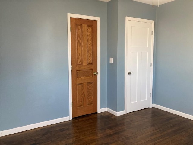 unfurnished bedroom featuring dark hardwood / wood-style floors