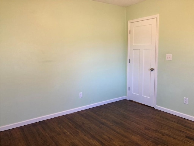 unfurnished room featuring dark hardwood / wood-style flooring