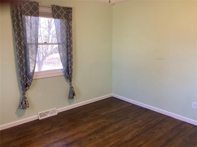 empty room featuring dark hardwood / wood-style floors and a wealth of natural light