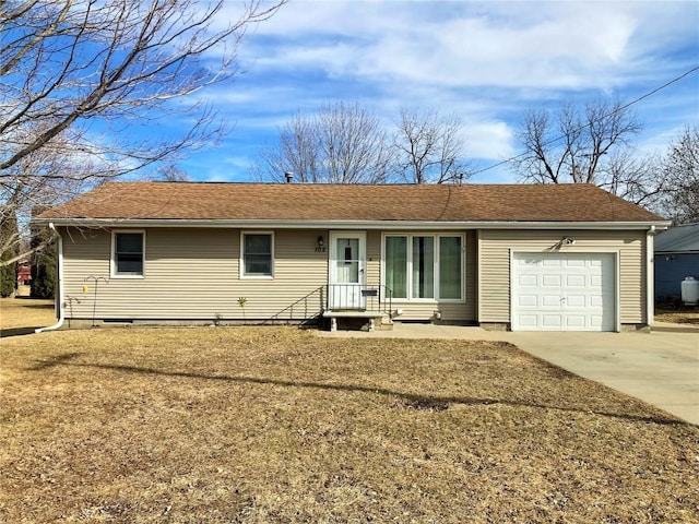 ranch-style home with a garage and a front lawn