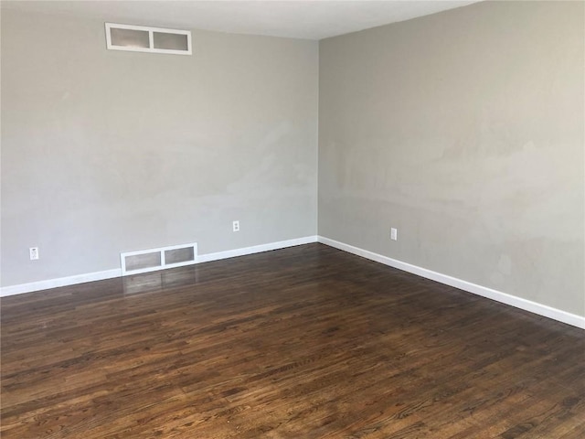 unfurnished room featuring dark hardwood / wood-style flooring