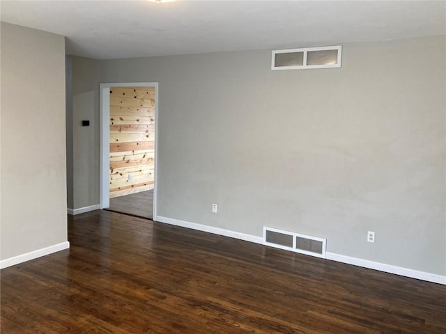 unfurnished room with dark hardwood / wood-style flooring