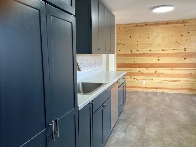 kitchen featuring sink and wooden walls