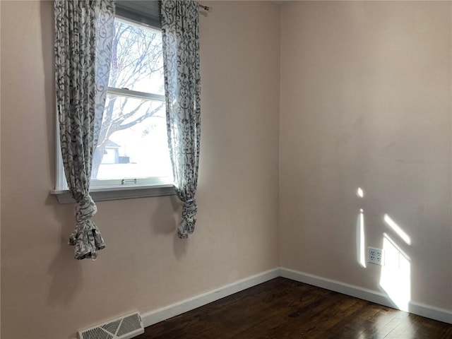 unfurnished room featuring dark hardwood / wood-style floors