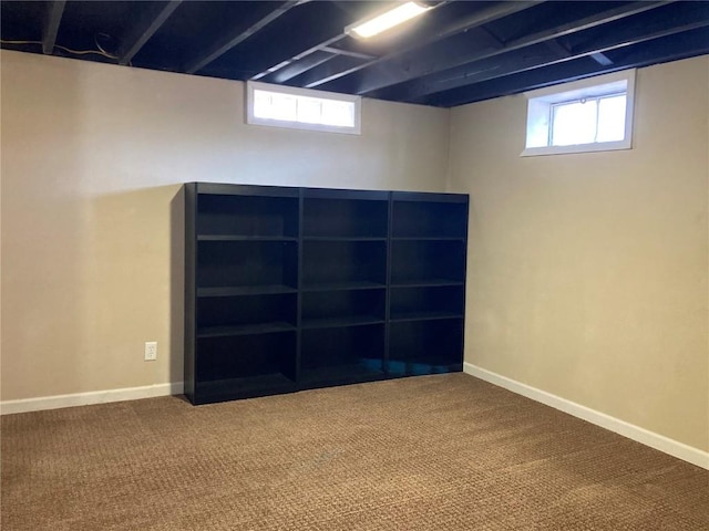 basement with a healthy amount of sunlight and carpet flooring