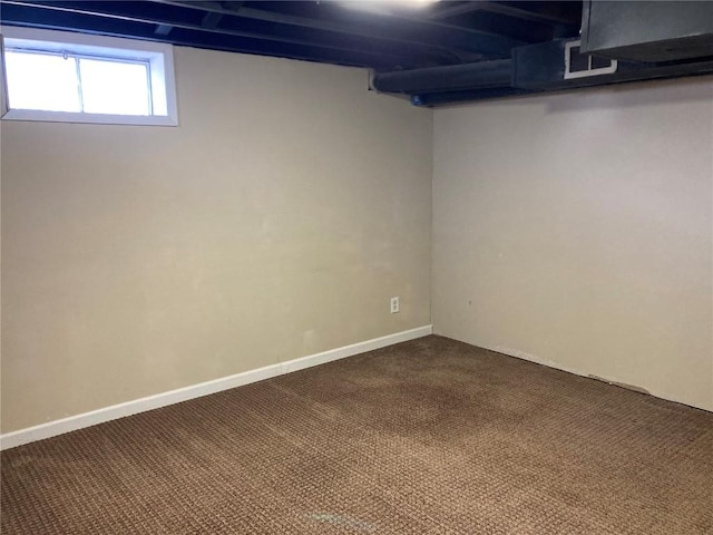 basement featuring dark carpet