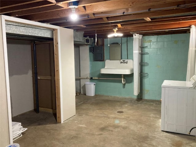 basement with washer / clothes dryer, electric panel, and sink