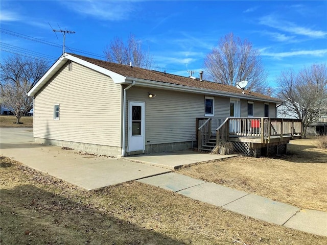 rear view of house with a patio area and a deck