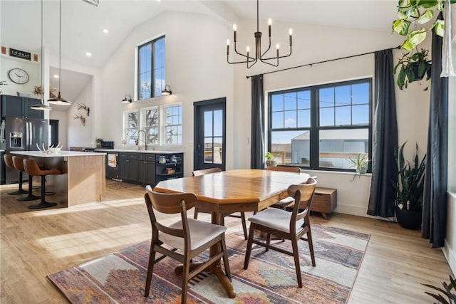 dining area featuring a wealth of natural light, sink, and light wood-type flooring