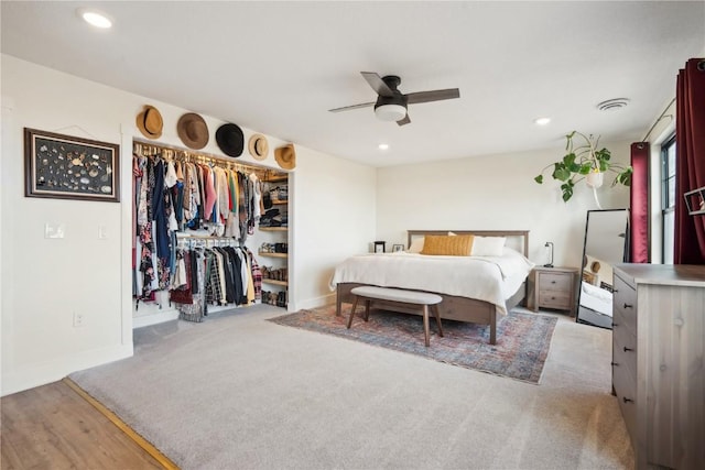 carpeted bedroom with ceiling fan and a closet