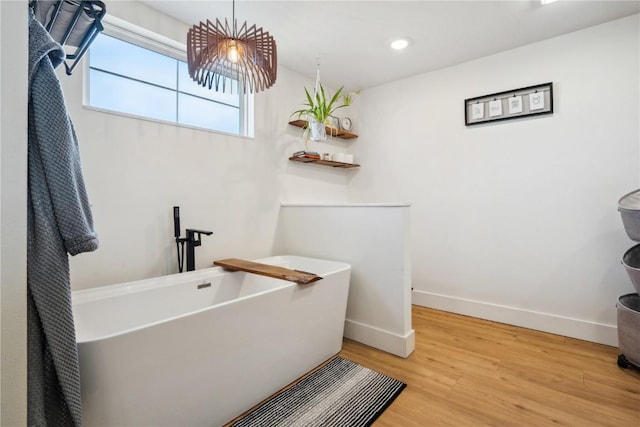 bathroom featuring hardwood / wood-style flooring and a bathing tub