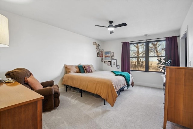 bedroom featuring ceiling fan and light carpet