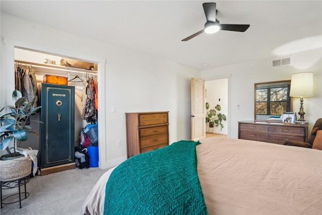 carpeted bedroom with ceiling fan and a closet