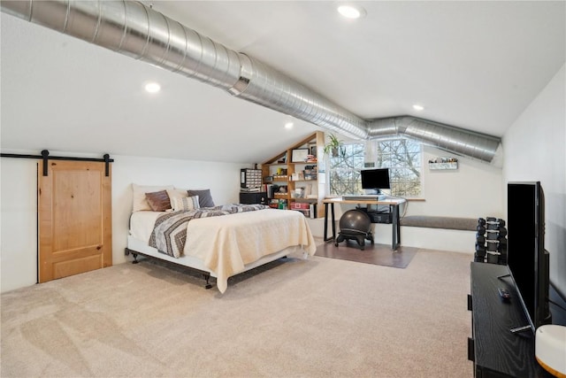 bedroom with a barn door, carpet flooring, and lofted ceiling