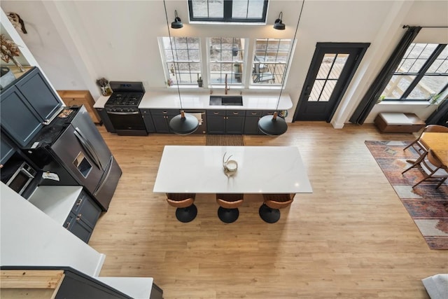 living room with sink and light hardwood / wood-style flooring