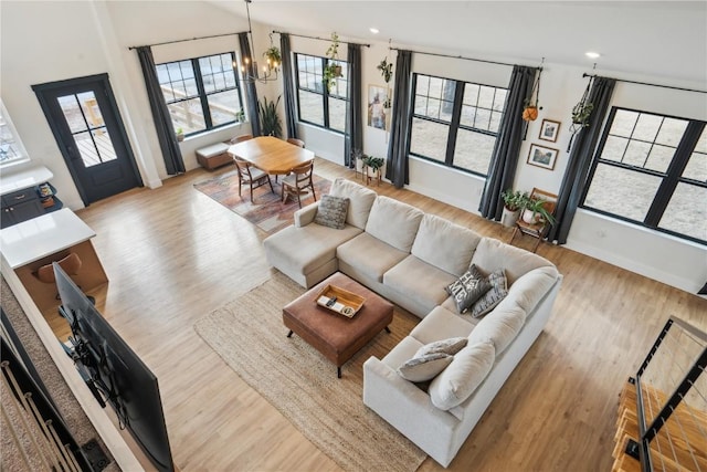 living room featuring a chandelier and light hardwood / wood-style floors