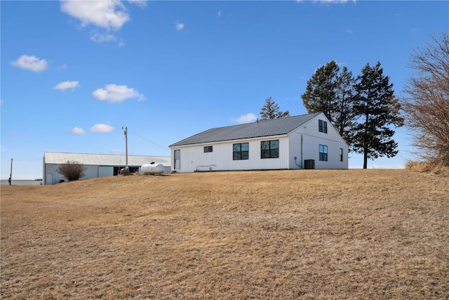 exterior space featuring cooling unit and a lawn