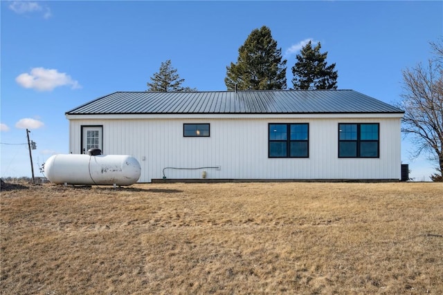 view of side of home with a yard