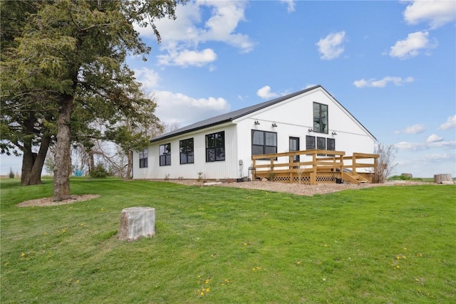 back of property with a yard and a deck