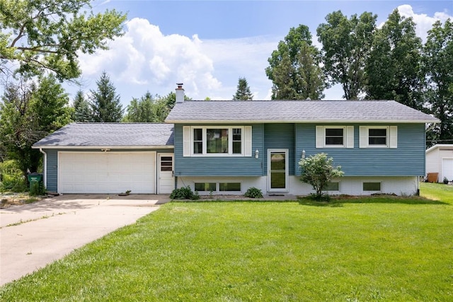 bi-level home with a garage and a front yard