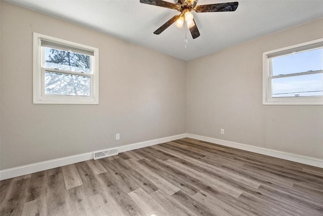 unfurnished room with ceiling fan and hardwood / wood-style floors