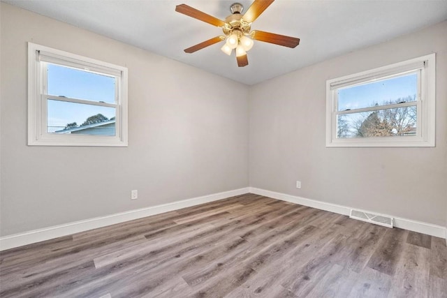 spare room with hardwood / wood-style floors and ceiling fan