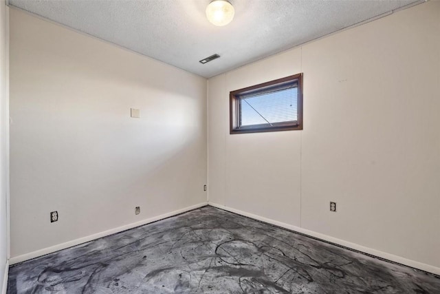 spare room featuring a textured ceiling