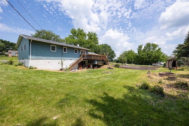 back of property featuring a lawn and a deck