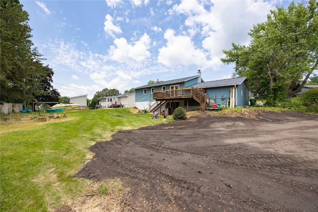 rear view of house with a lawn and a deck