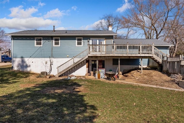 back of property featuring a yard and a deck