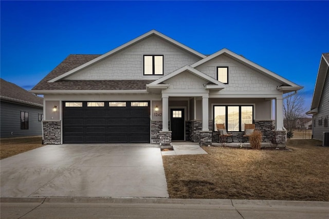 craftsman house with a garage and covered porch